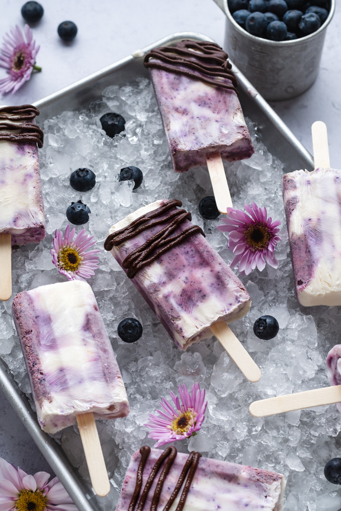blueberry popsicles with lemon zest honey chocolate drizzle