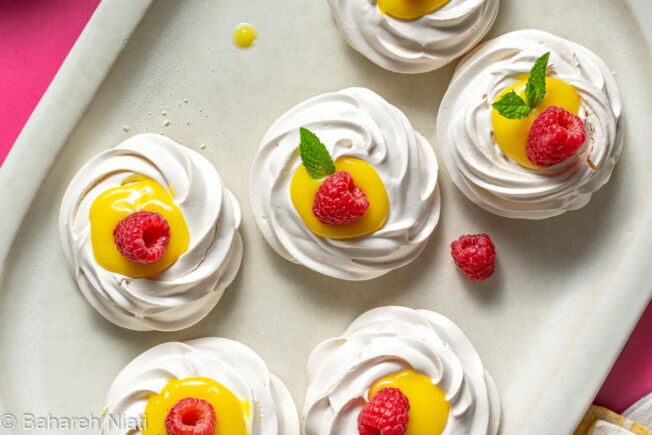 mini pavlovas with lemon curd and raspberries