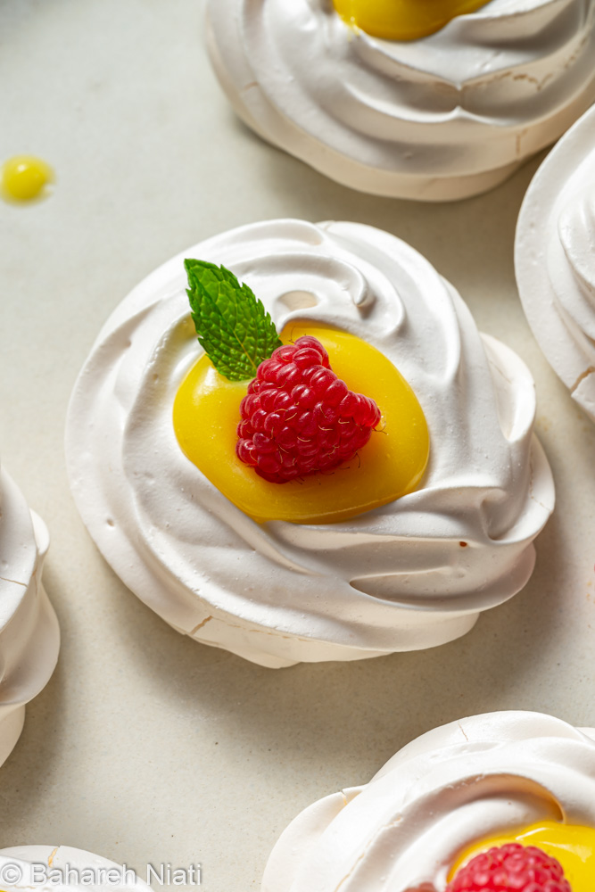 mini pavlovas with lemon curd and raspberries